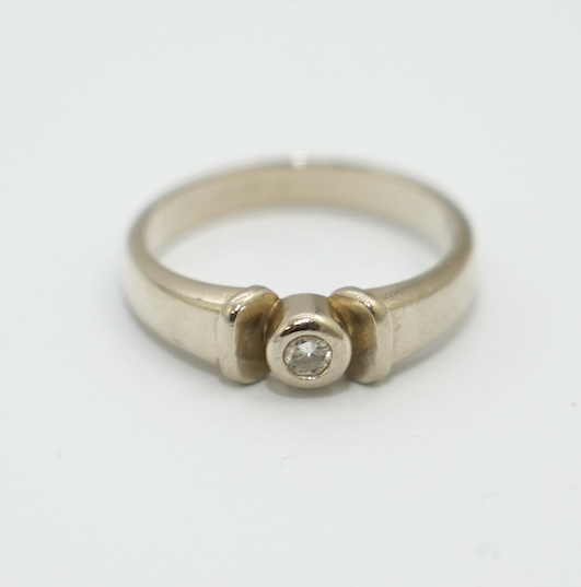 A mid to late 20th century Polish 583 standard white metal and solitaire diamond chip set ring, size N, gross weight 4.3 grams. Condition - fair